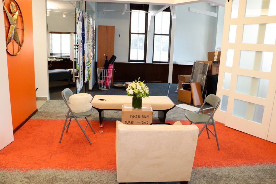 The lounge with seating and an orange rug